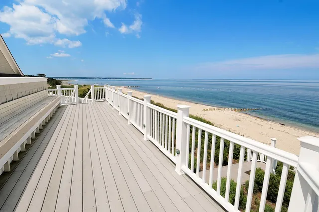 a view of balcony with wooden floor and fence