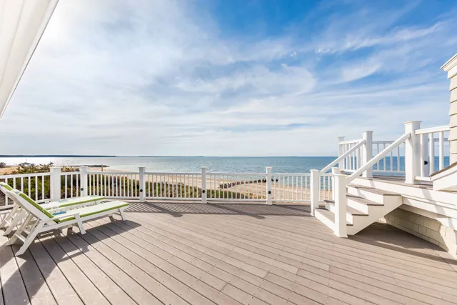 a view of a deck with wooden floor and fence