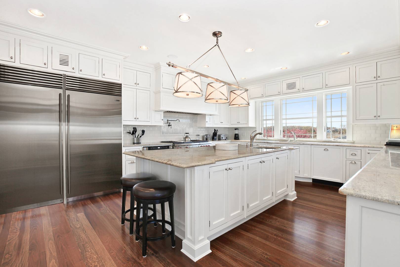 351 Kings Point Road East Hampton, NY 11937 - Photo 8 of 34 a kitchen with stainless steel appliances granite countertop a refrigerator a sink dishwasher a stove and white cabinets with wooden floor