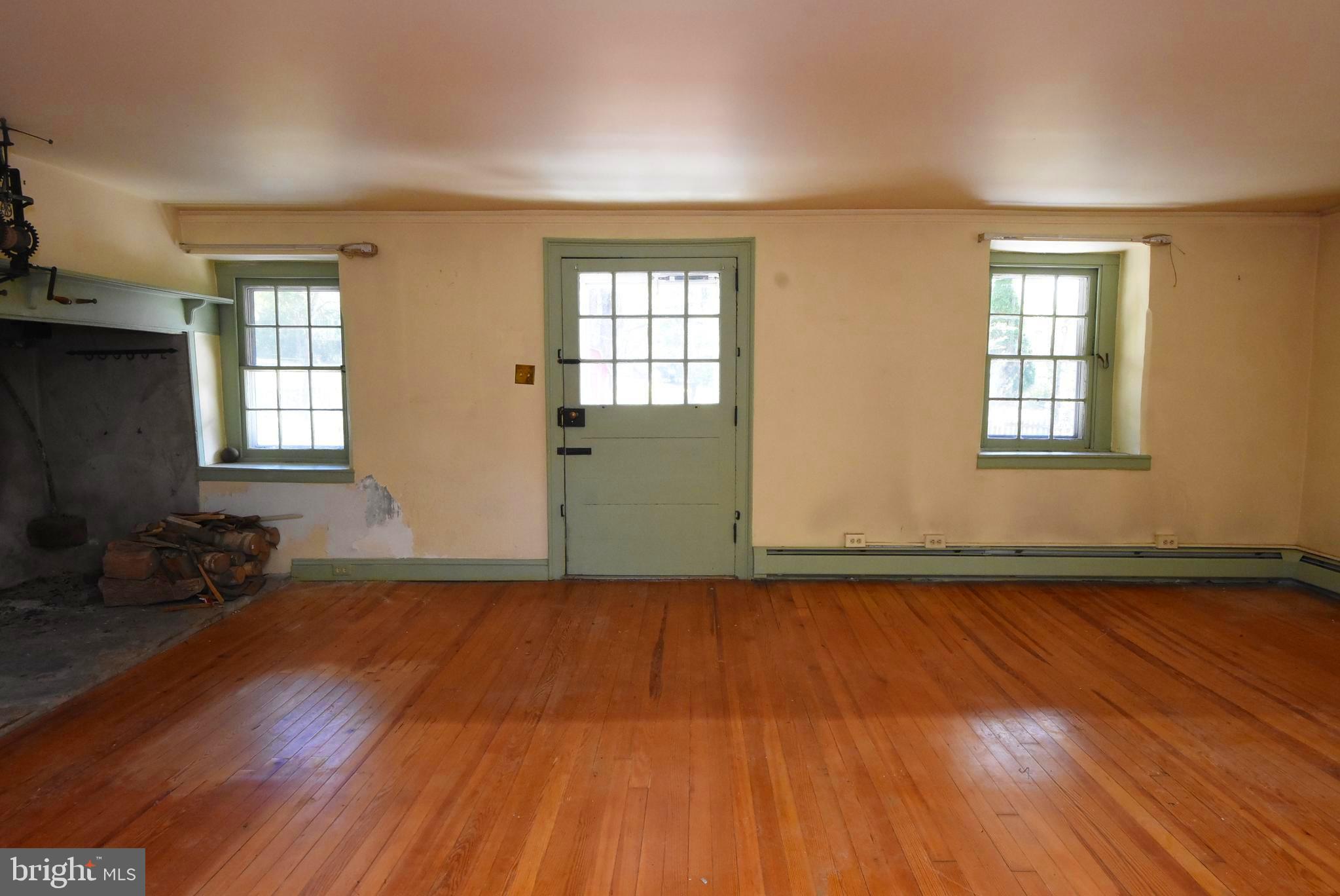 210 Buckwalter Road Phoenixville, PA 19460 - Photo 11 of 60 an empty room with wooden floor and windows