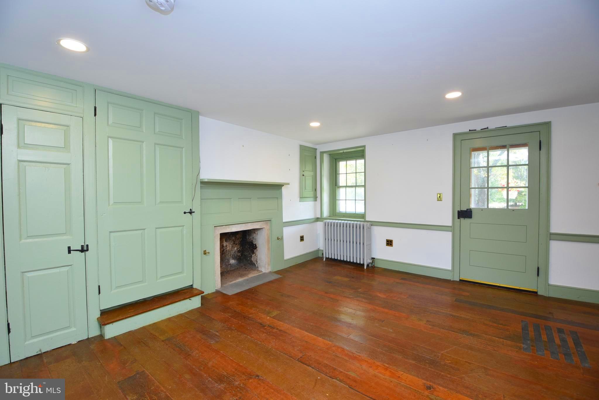 210 Buckwalter Road Phoenixville, PA 19460 - Photo 18 of 60 an empty room with a fireplace and windows