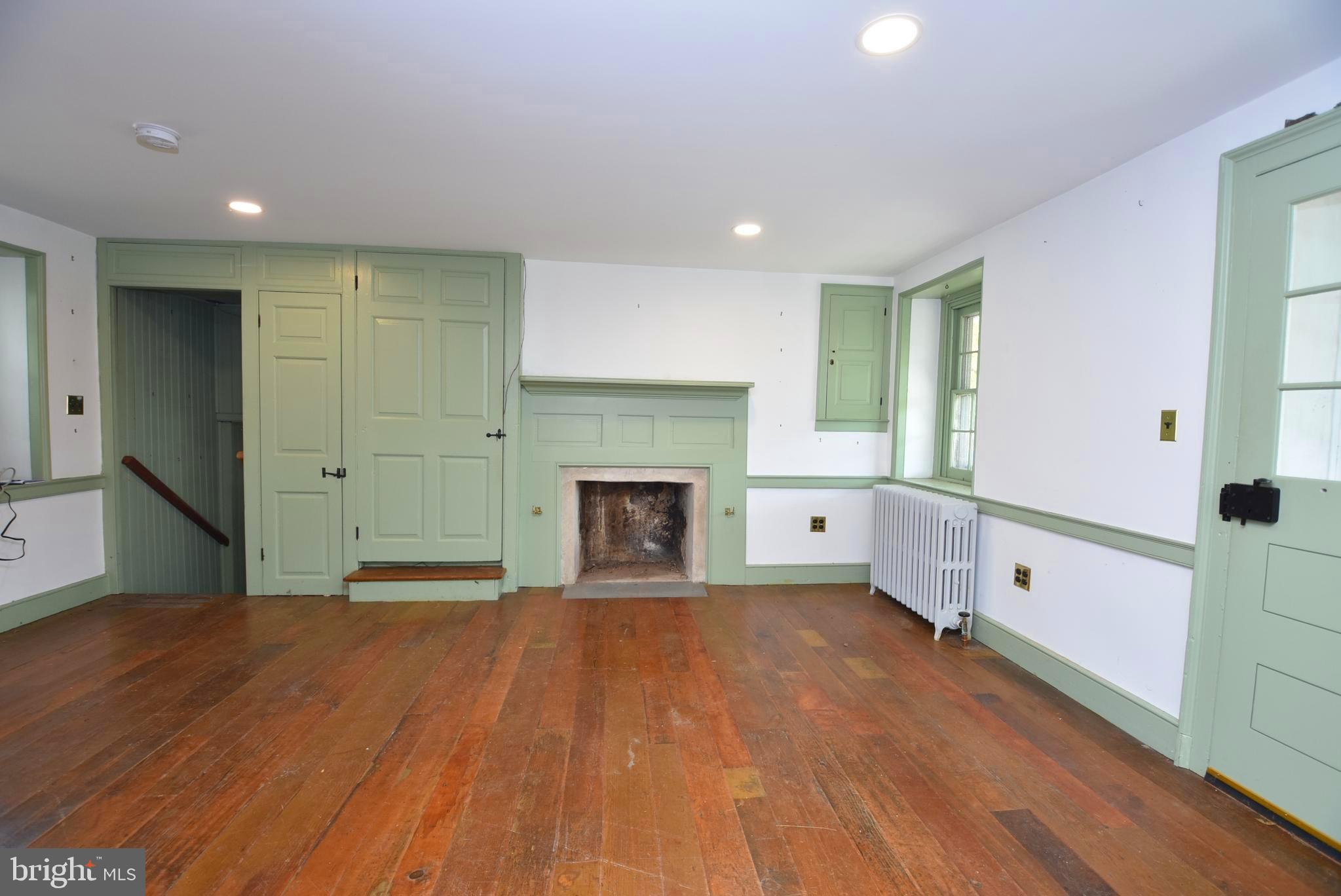 210 Buckwalter Road Phoenixville, PA 19460 - Photo 23 of 60 a view of empty room with wooden floor and fireplace
