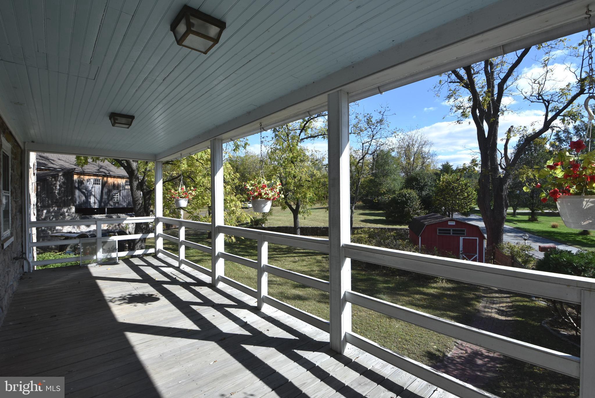 210 Buckwalter Road Phoenixville, PA 19460 - Photo 25 of 60 a view of a porch with wooden floor table and chairs