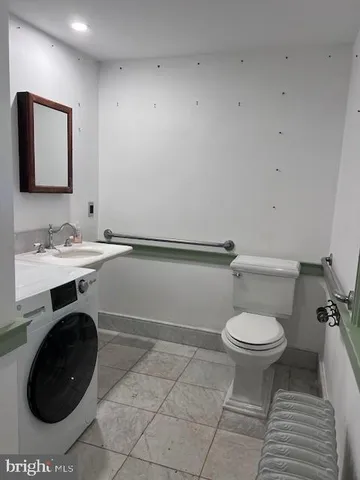 a view of an empty room with closet and a window