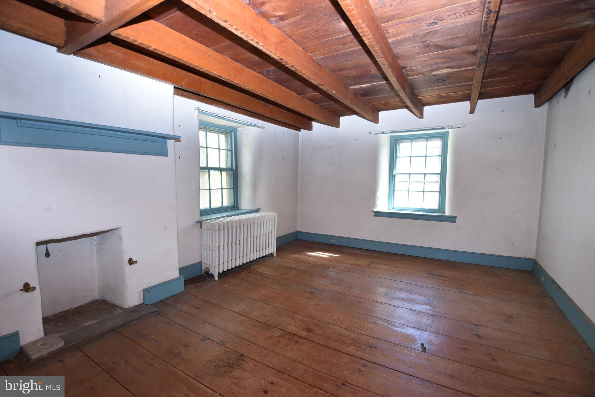 210 Buckwalter Road Phoenixville, PA 19460 - Photo 29 of 60 an empty room with wooden floor and windows