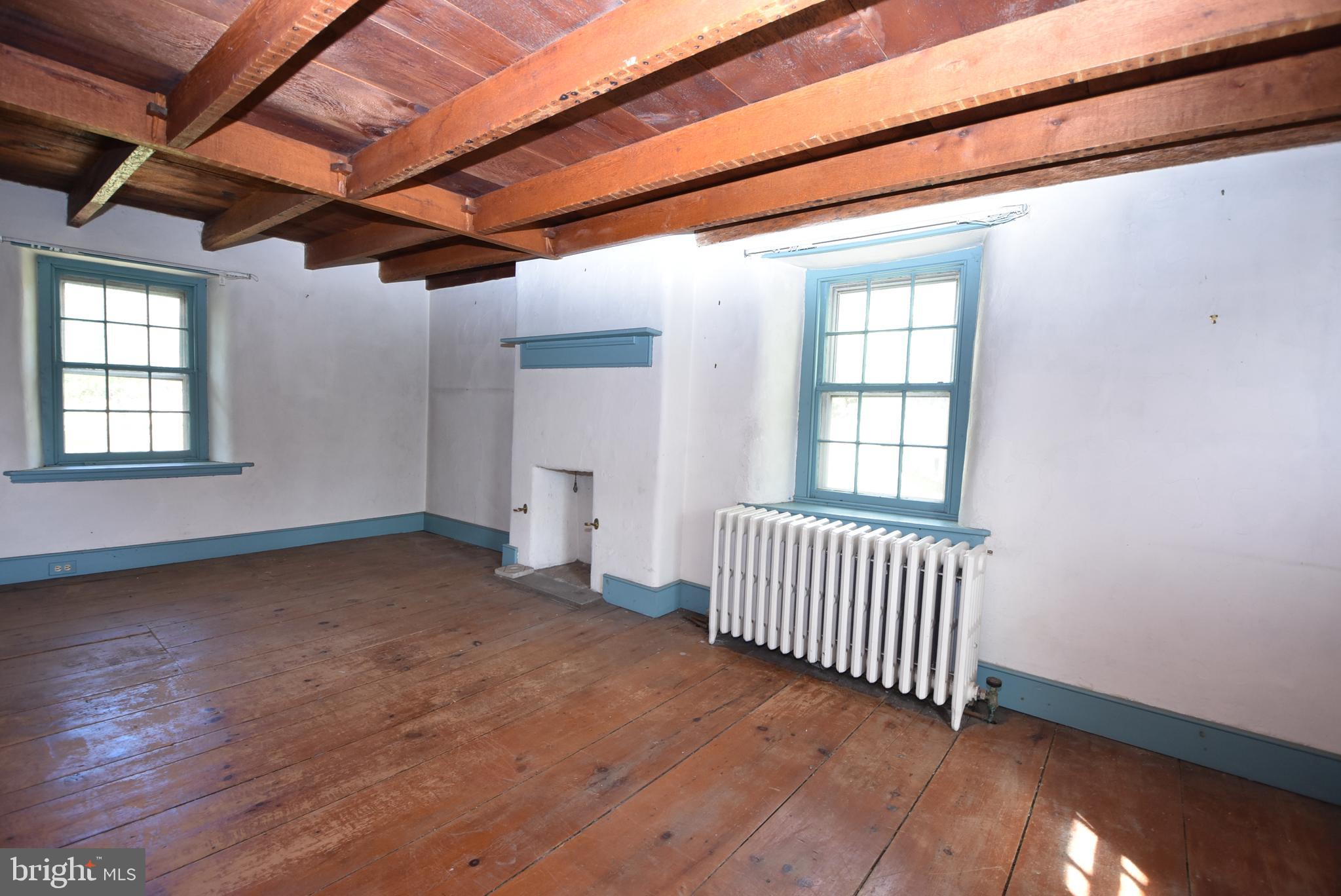 210 Buckwalter Road Phoenixville, PA 19460 - Photo 30 of 60 a view of an empty room with wooden floor and a window