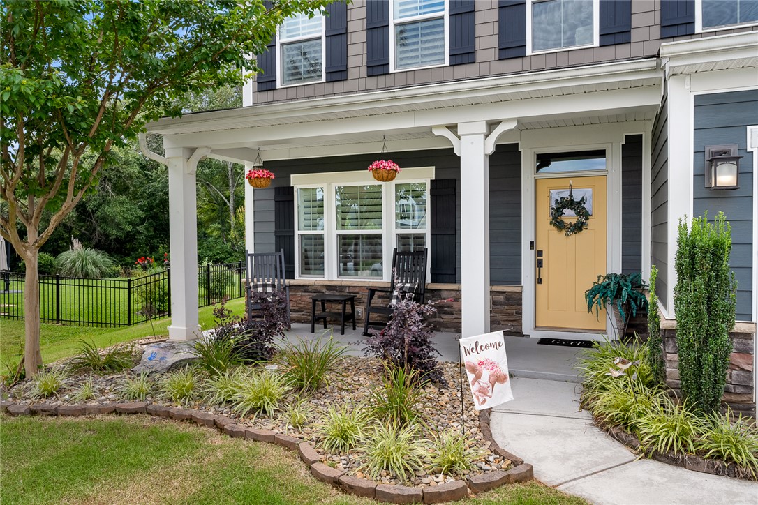 216 Bronson Ridge Anderson, SC 29621 - Photo 2 of 45 A charming entry with a sunny yellow door and inviting porch seating welcomes you home.