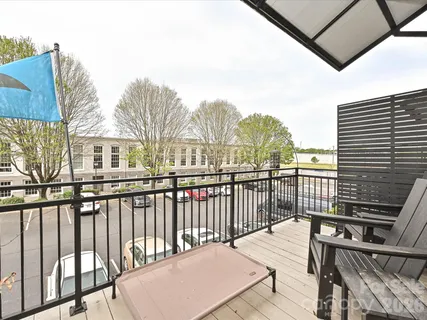 a view of a balcony with furniture