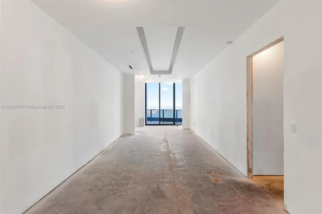 a view of an empty room and a window