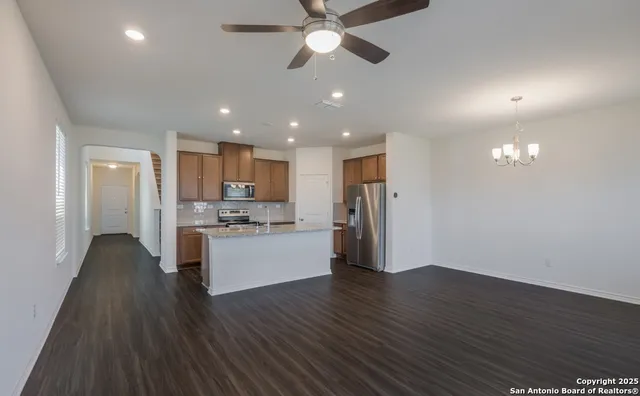 a view of a kitchen with a sink and refrigerator