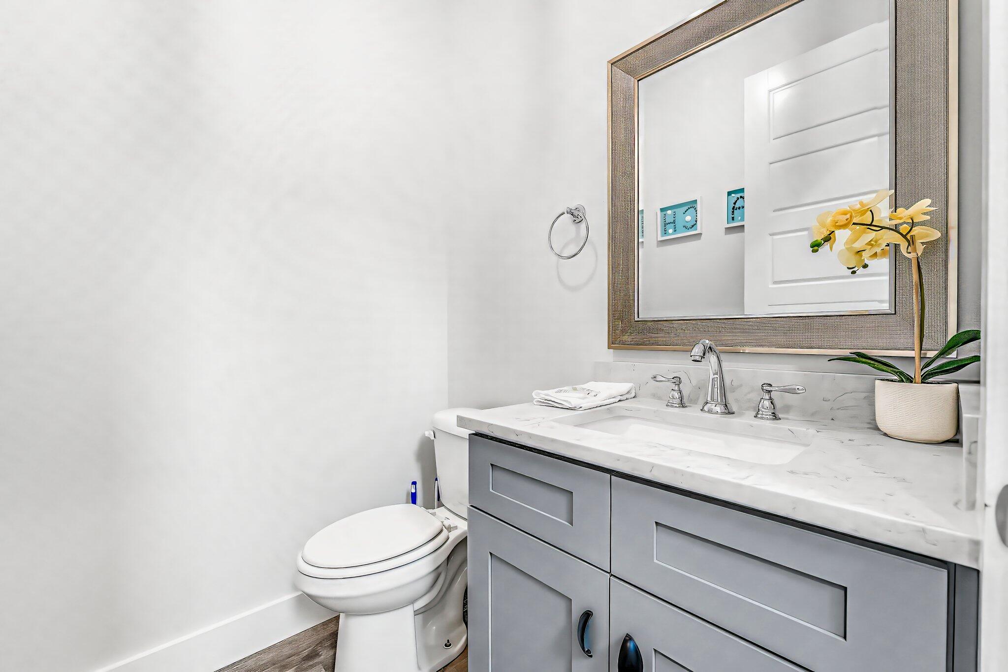 550 Gulfview Circle Santa Rosa Beach, FL 32459 - Photo 13 of 44 a bathroom with a granite countertop toilet sink and mirror