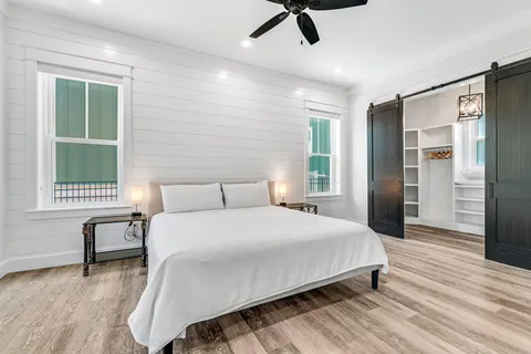 a bedroom with a bed and a window