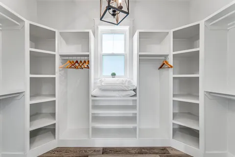 a view of walk in closet with empty racks