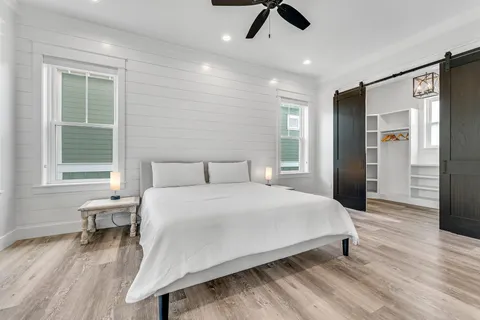 a spacious bedroom with a bed and a window