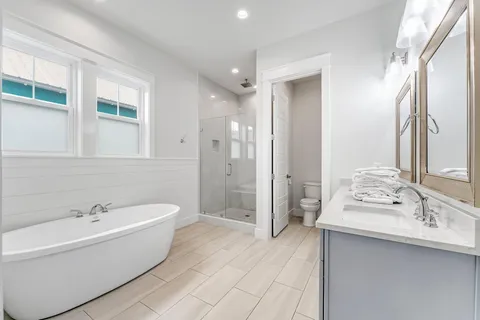 a bathroom with a bathtub shower and a sink