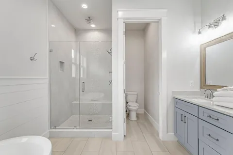 a bathroom with a toilet a sink and shower