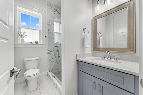 a bathroom with a toilet sink and mirror