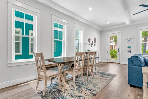 a view of a dining room with furniture window and wooden floor
