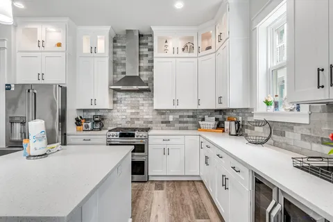 a kitchen with cabinets appliances and a window