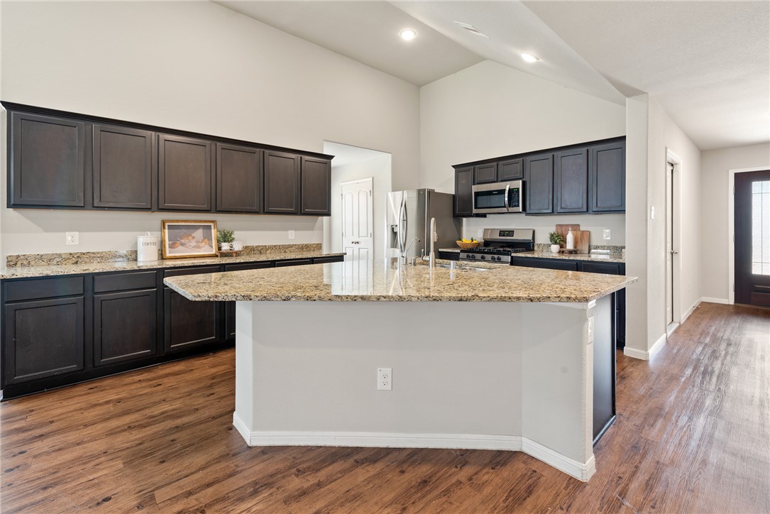 2018 Eagle View Drive Navasota, TX 77868 - Photo 4 of 28 a kitchen with stainless steel appliances granite countertop a stove a sink a microwave a refrigerator and cabinets