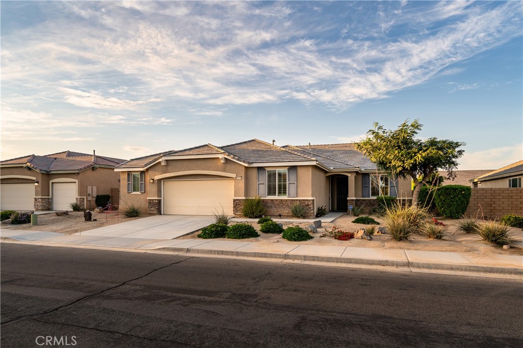 82872 Wordsworth Court Indio, CA 92201 - Photo 3 of 62 a front view of a house with a garden and pathway