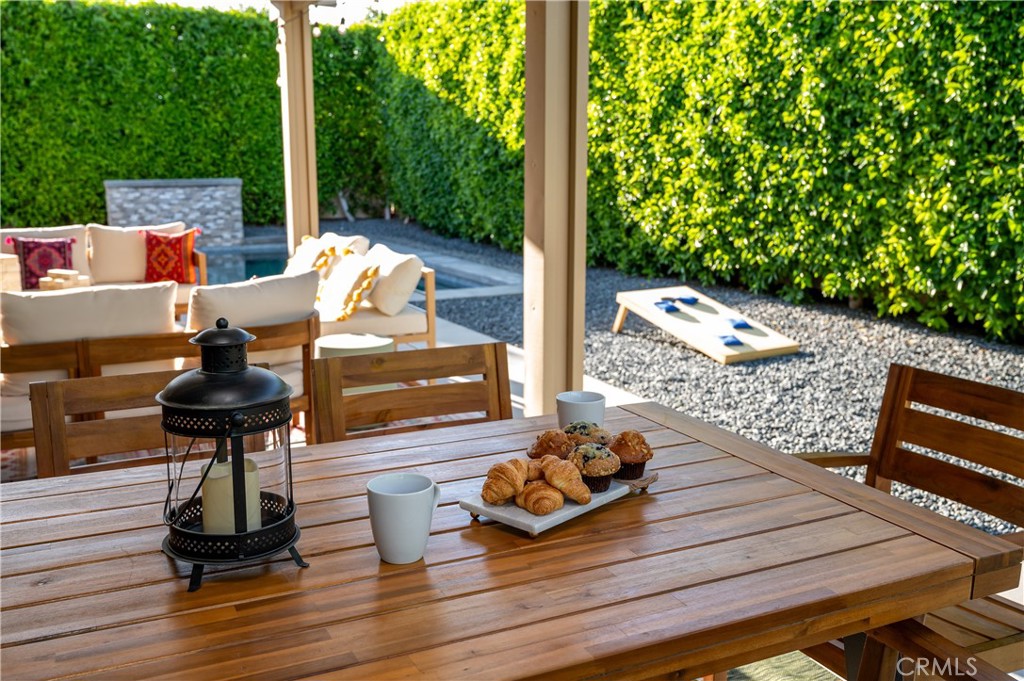 82872 Wordsworth Court Indio, CA 92201 - Photo 47 of 62 a view of a deck with couches table and chairs with wooden floor
