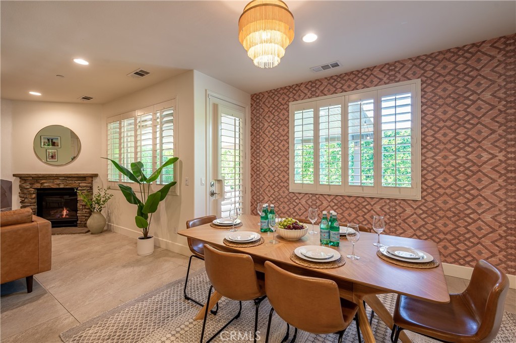 82872 Wordsworth Court Indio, CA 92201 - Photo 8 of 62 a view of a dining room with furniture a fireplace and wooden floor