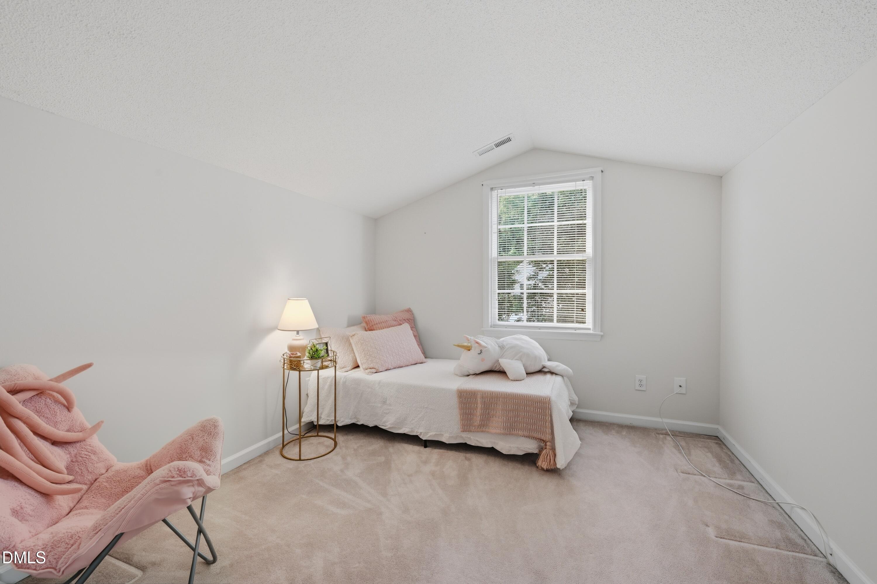 6801 Lynnoak Drive Raleigh, NC 27613 - Photo 19 of 30 a bedroom with a bed chair and window