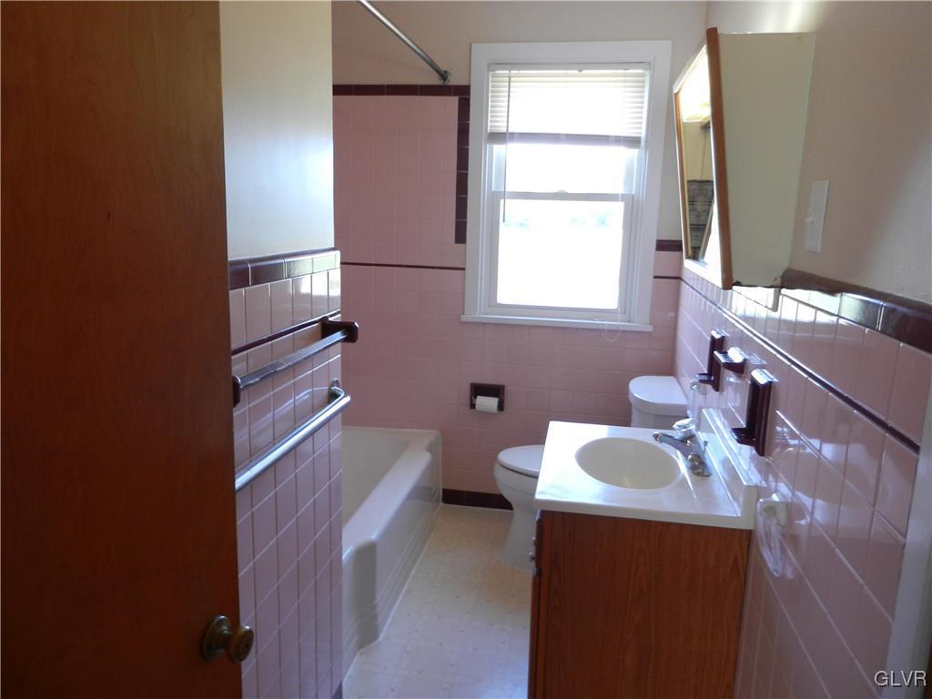5027 Huckleberry Road Orefield, PA 18069 - Photo 13 of 17 a bathroom with a sink a toilet and tub