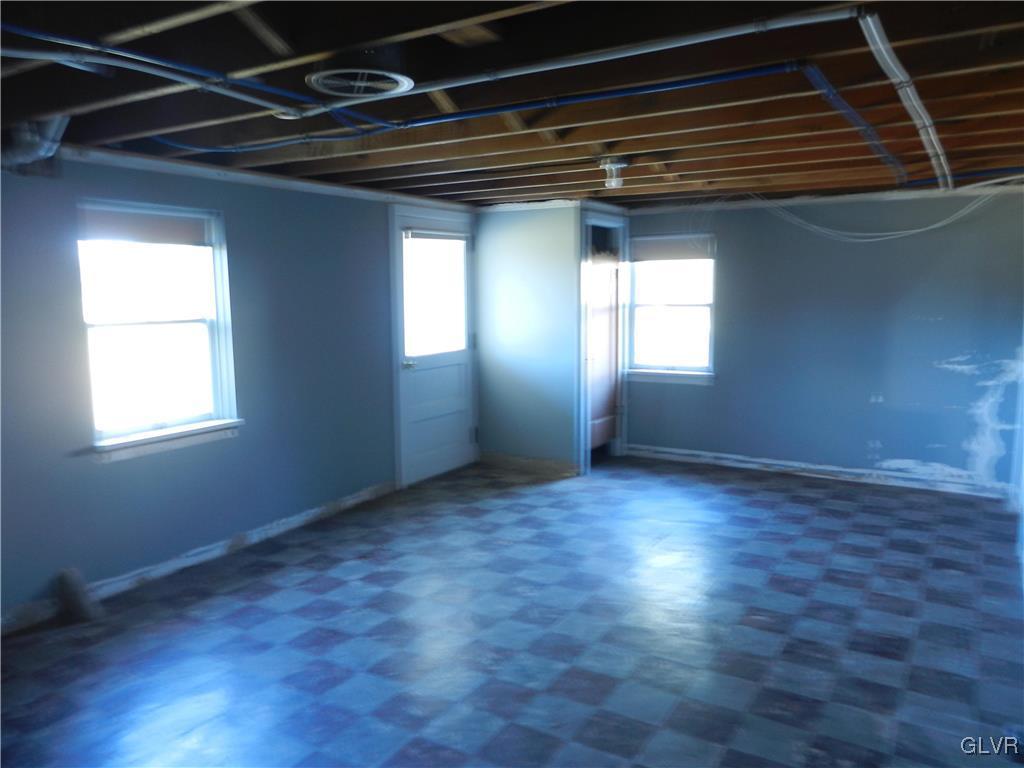 5027 Huckleberry Road Orefield, PA 18069 - Photo 17 of 17 an empty room with wooden floor and windows