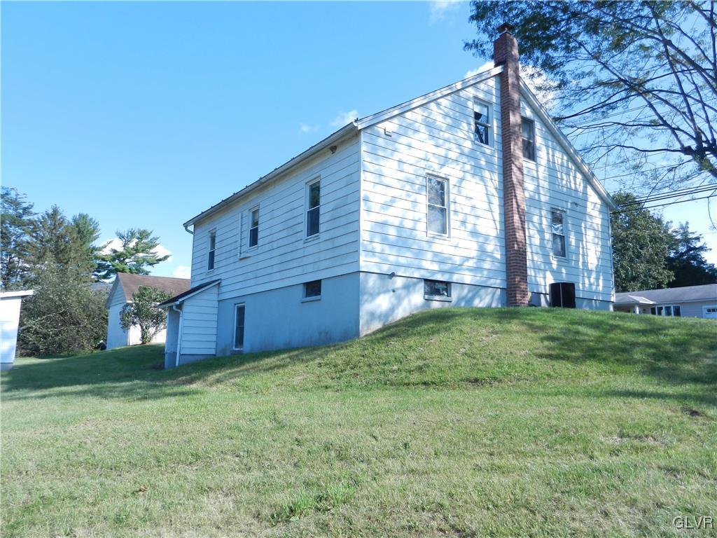 5027 Huckleberry Road Orefield, PA 18069 - Photo 5 of 17 a view of a house with a big yard and large tree