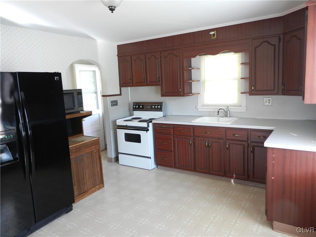 5027 Huckleberry Road Orefield, PA 18069 - Photo 7 of 17 a kitchen with stainless steel appliances granite countertop a refrigerator stove and sink