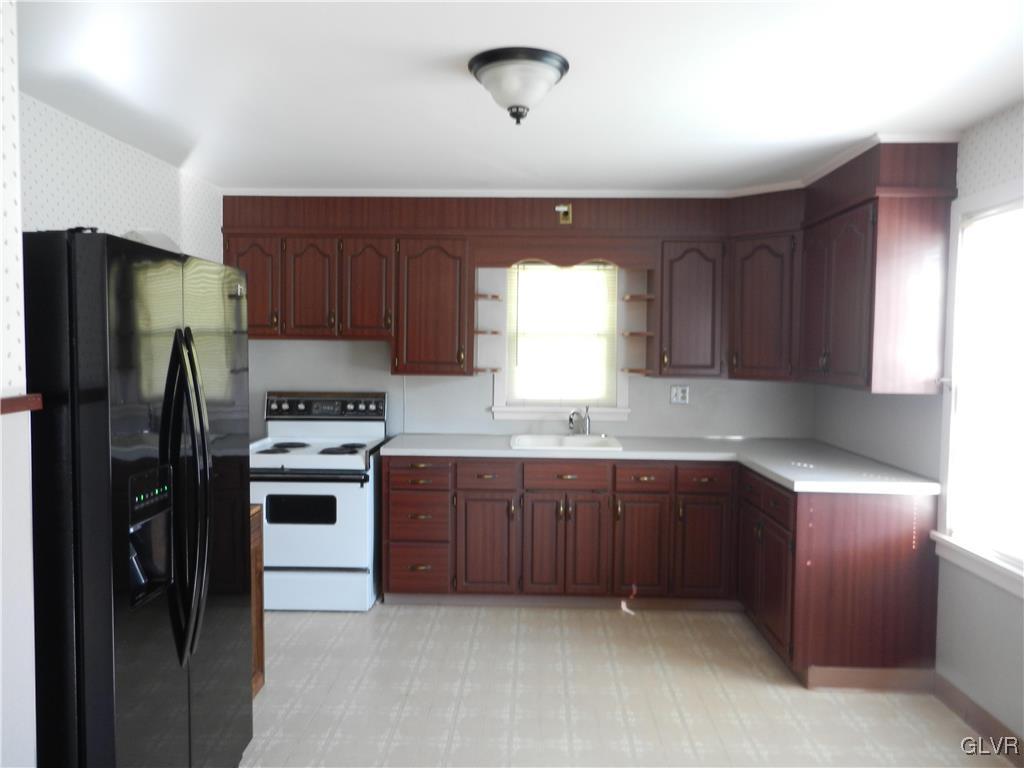 5027 Huckleberry Road Orefield, PA 18069 - Photo 8 of 17 a kitchen with stainless steel appliances granite countertop a refrigerator stove and sink