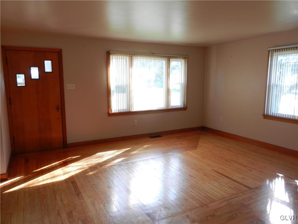 5027 Huckleberry Road Orefield, PA 18069 - Photo 9 of 17 a view of an empty room with wooden floor and a window
