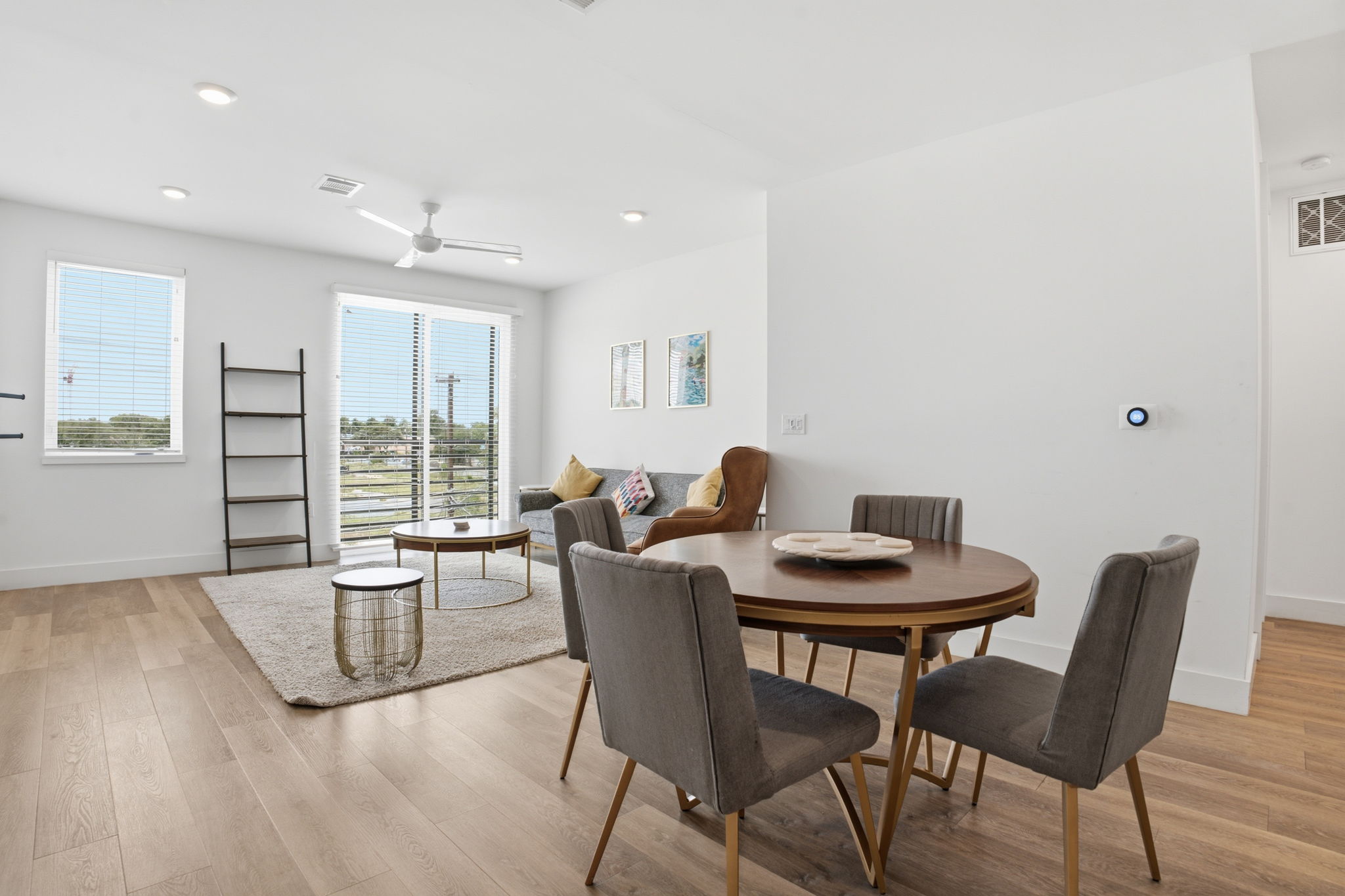 2709 East 5th Street, Unit 1306 Austin, TX 78702 - Photo 28 of 28 An open floorplan living and dining area features abundant natural light and rich wood flooring.
