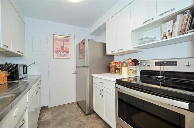 a kitchen with stainless steel appliances and cabinets