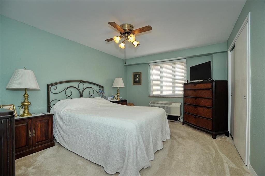 4625 Fifth Avenue, Unit 211 Pittsburgh, PA 15213 - Photo 12 of 14 a bedroom with a bed and a television