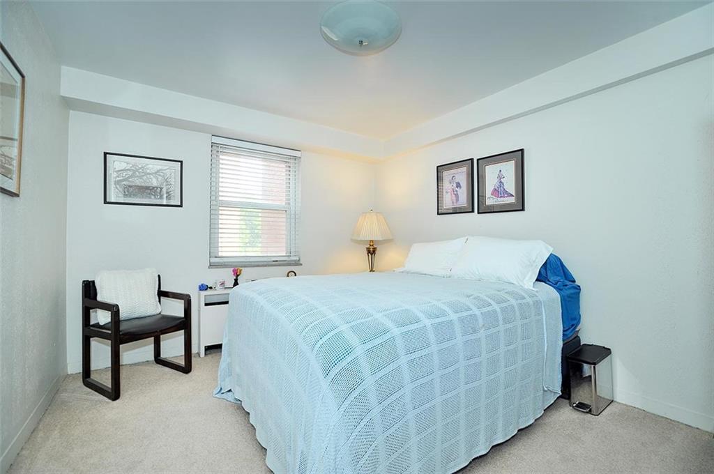 4625 Fifth Avenue, Unit 211 Pittsburgh, PA 15213 - Photo 13 of 14 a bedroom with a bed and a table