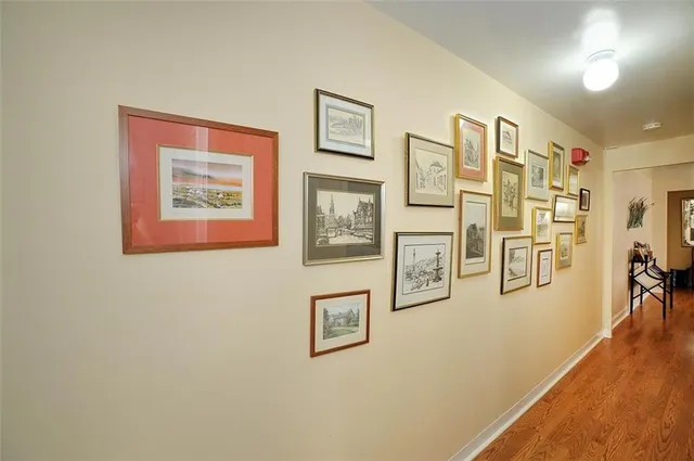a view of a hallway with painting on the wall