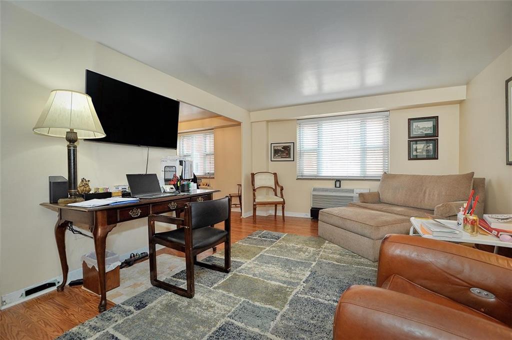 4625 Fifth Avenue, Unit 211 Pittsburgh, PA 15213 - Photo 7 of 14 a living room with furniture a lamp and a flat screen tv