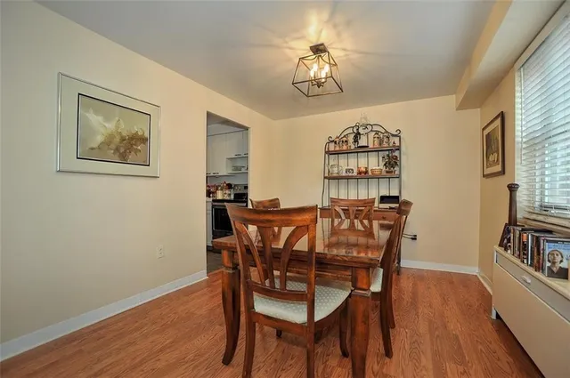 a view of a dining room with furniture and wooden floor