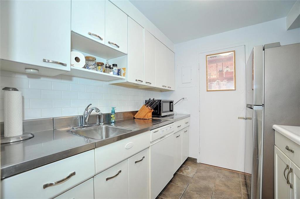 4625 Fifth Avenue, Unit 211 Pittsburgh, PA 15213 - Photo 10 of 14 a kitchen with cabinets and a sink