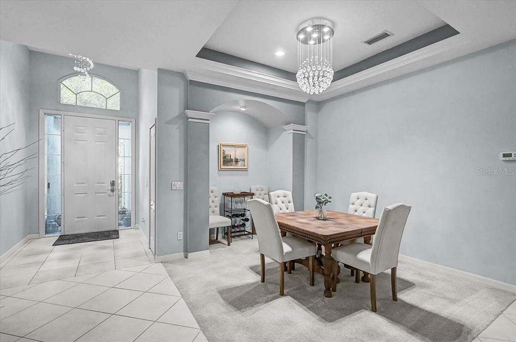 103 Bishopscourt Road Osprey, FL 34229 - Photo 3 of 55 a view of a dining room with furniture and a chandelier