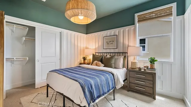 a bedroom with a bed and a chandelier