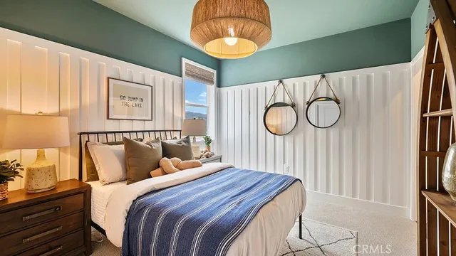 a bedroom with a bed and a painting on the wall