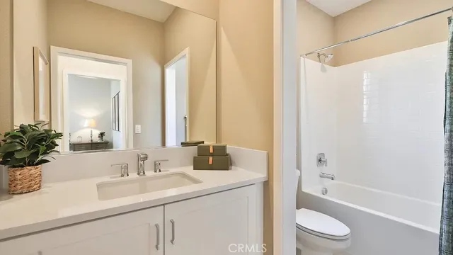 a bathroom with a sink a toilet a tub and shower