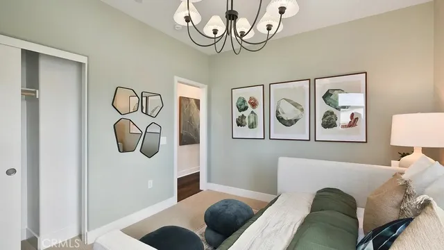 a bedroom with a bed and painting on the wall