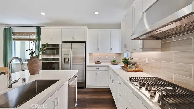a kitchen with a sink stove and refrigerator