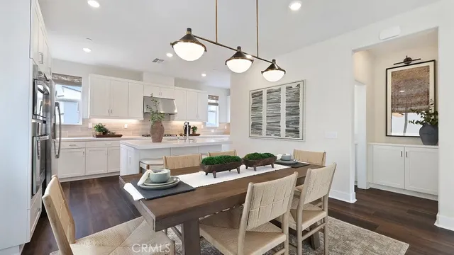 a kitchen with a table and chairs in it