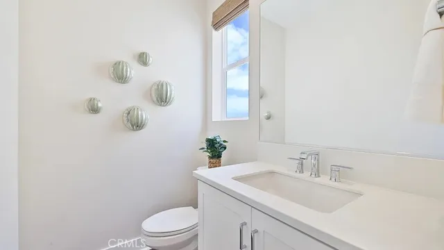 a bathroom with a sink toilet and mirror